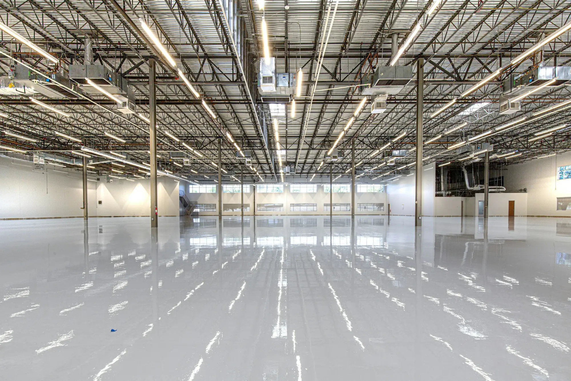 Empty warehouse with a polished, gleaming concrete floor